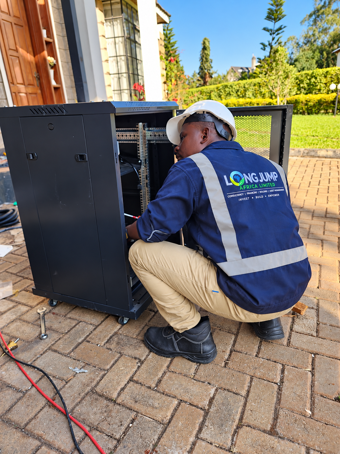 Technician fitting electrical equipment